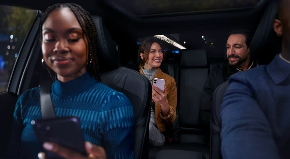 Smiling people are shown in a 2025 Toyota Camry XSE.