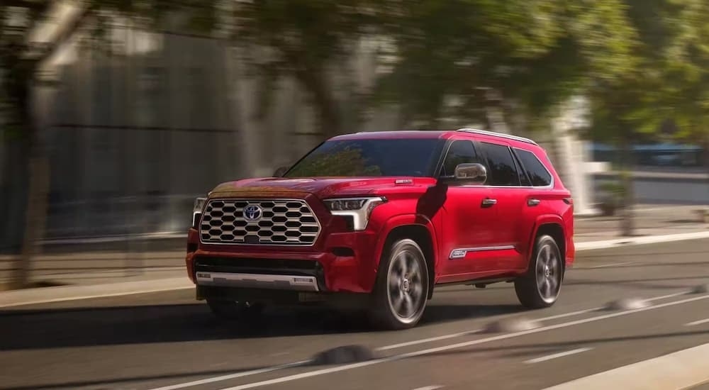 A red 2023 Toyota Sequoia is shown from the front at an angle after leaving a dealer that has used SUVs for sale in Westminster.