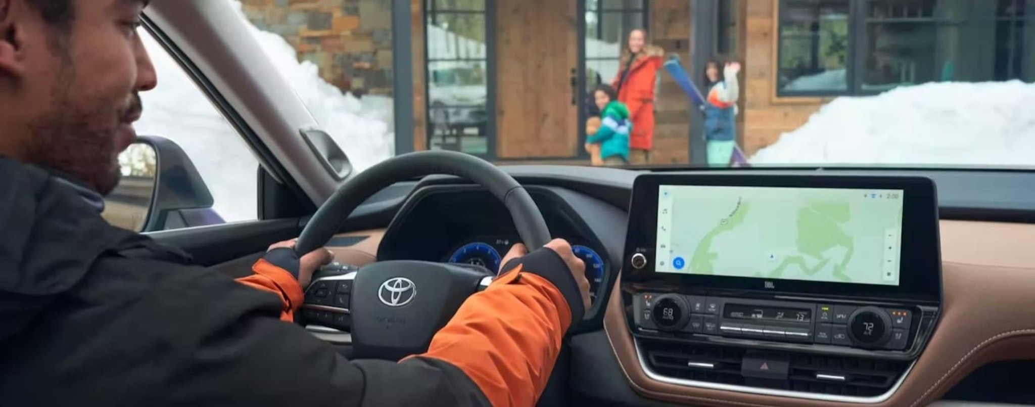 A person is shown looking at the infotainment screen in a 2024 Toyota Grand Highlander.