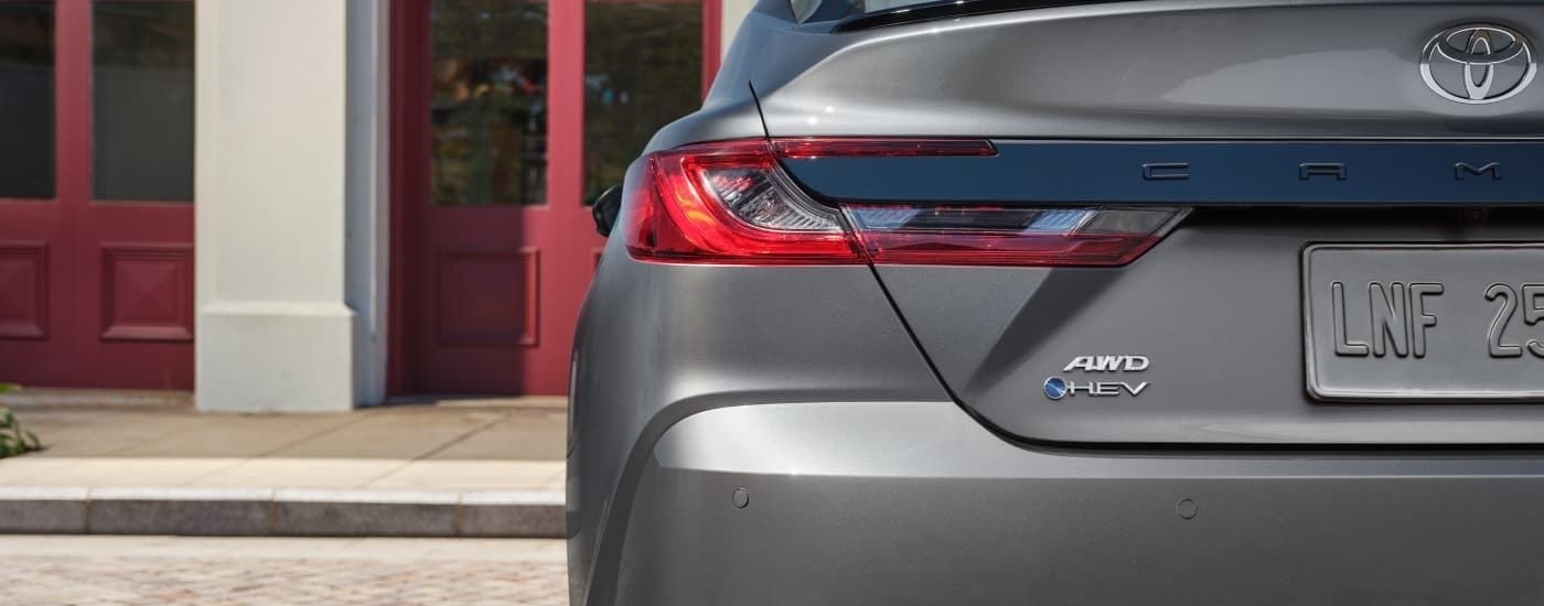 A close up shows the driver side taillight on a silver 2025 Toyota Camry.