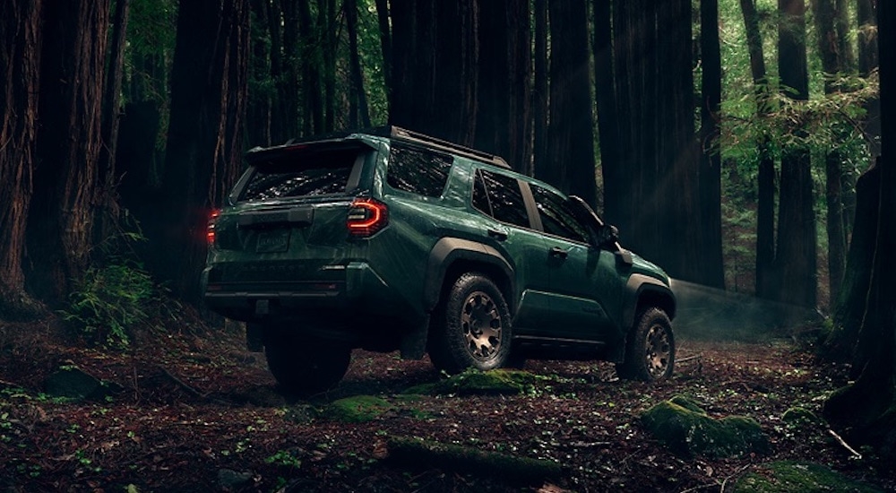 A green 2025 Toyota 4Runner Trailhunter parked in a forest.