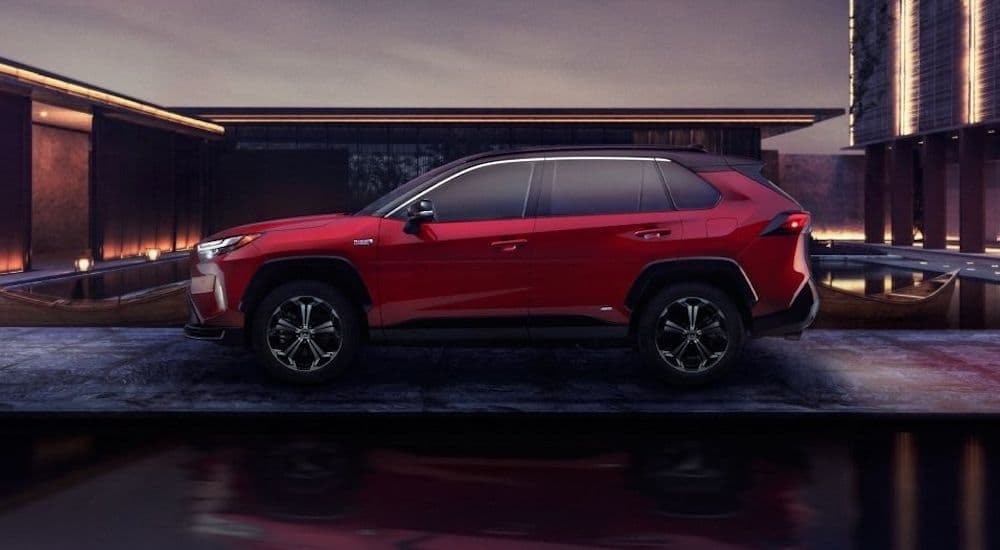 A red 2024 Toyota RAV4 Prime parked after leaving a dealer that has a Toyota RAV4 for sale.