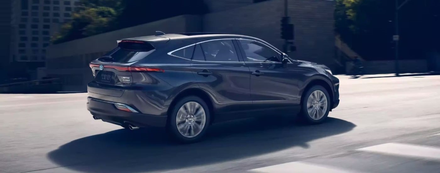 A grey 2023 Toyota Venza Limited is shown driving past a crosswalk.