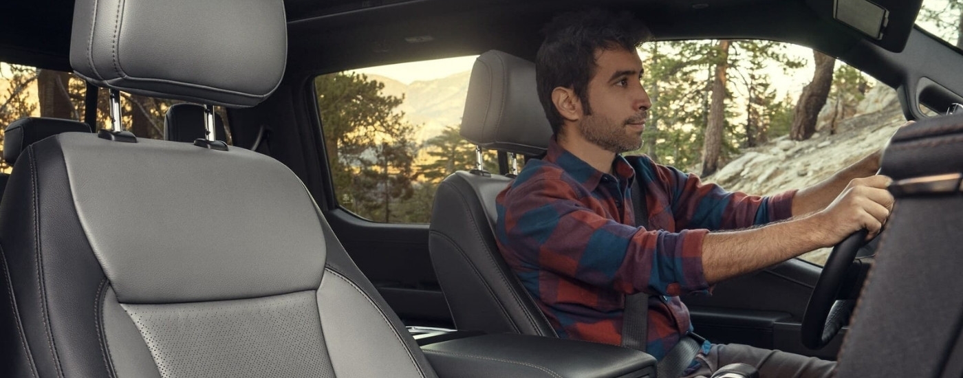 A person is shown driving a 2024 Ford F-150 Lightning.