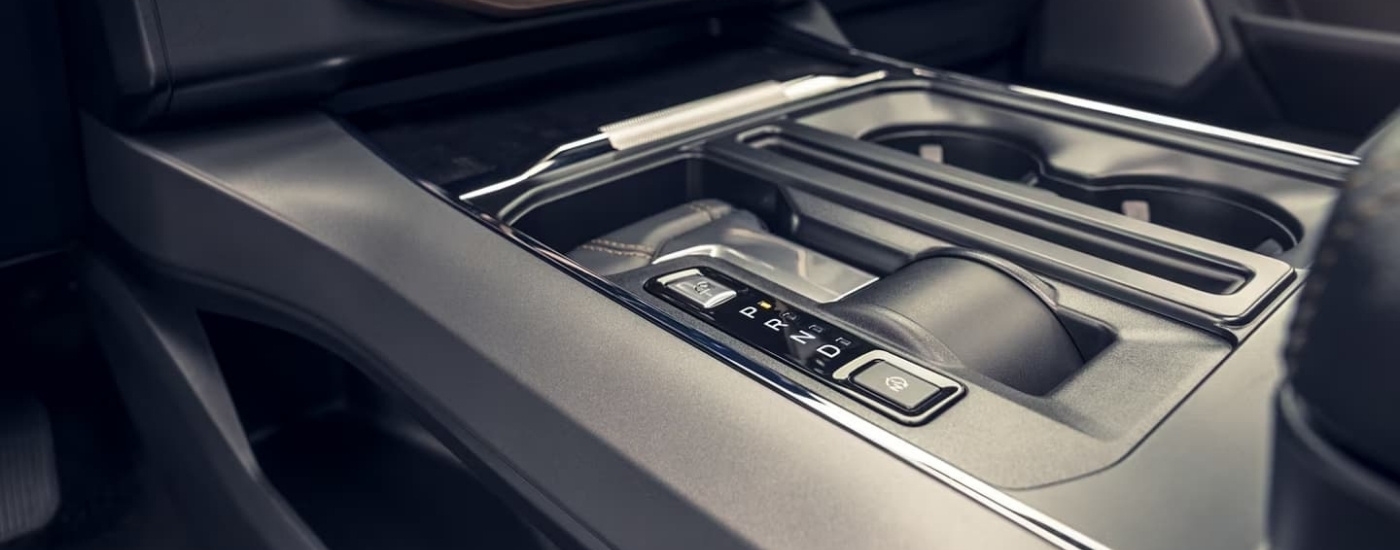 A close up shows the black gear shifter in a 2022 Ford F-150 Lightning.