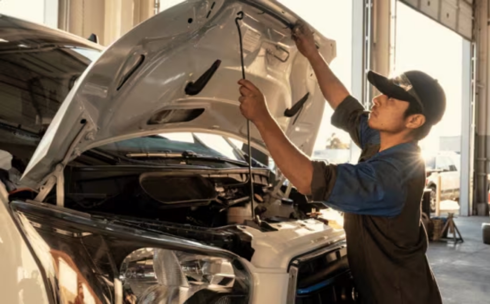 Lifting up the hood of a Ford