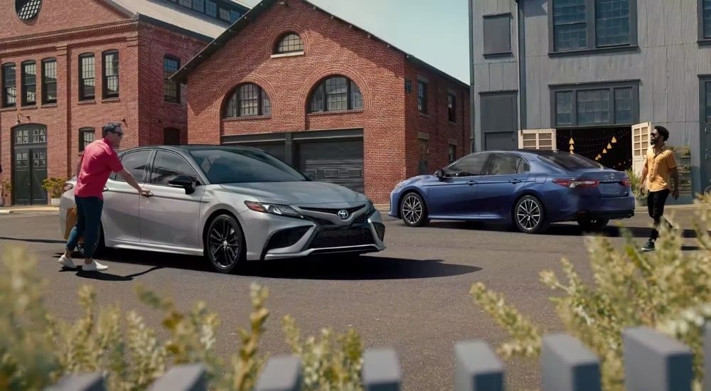 A grey and a blue 2023 Toyota Camry are shown after leaving a Toyota dealer near Brattleboro.