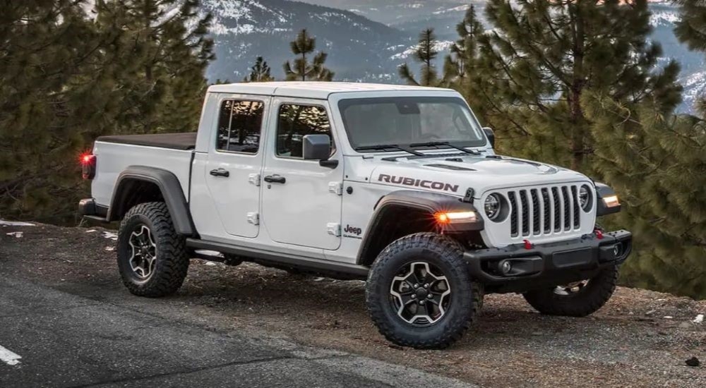 A white 2023 Jeep Gladiator Rubicon parked on a mountain road.