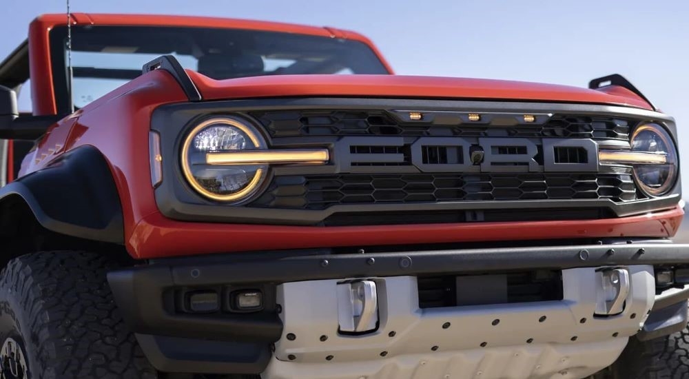 A close-up on the grille of a red 2024 Ford Bronco Raptor.