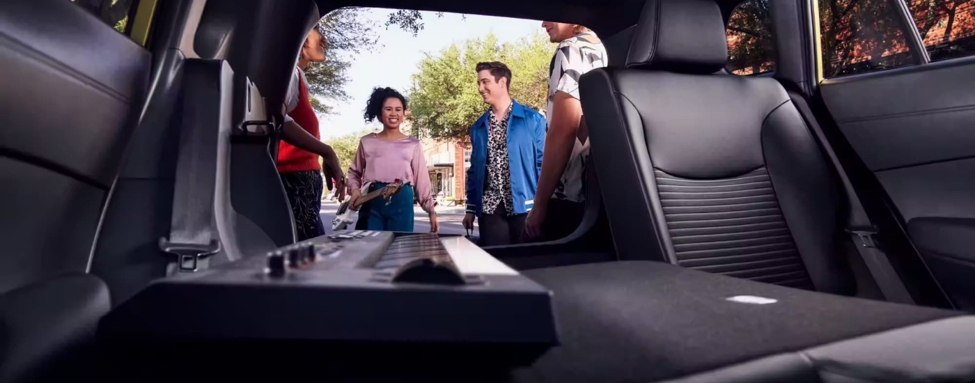 A keyboard is shown in the trunk of a 2024 Toyota Corolla Cross for sale.