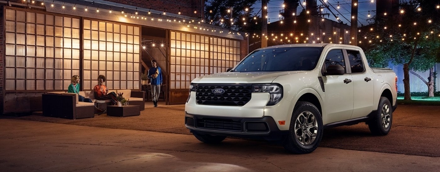 A white 2025 Ford Maverick XLT is shown at night.