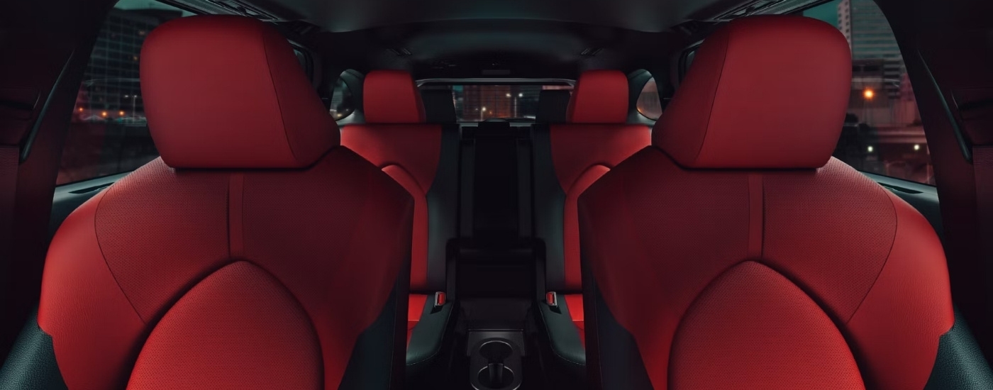 The red and black interior is shown in a 2024 Toyota Highlander XSE.