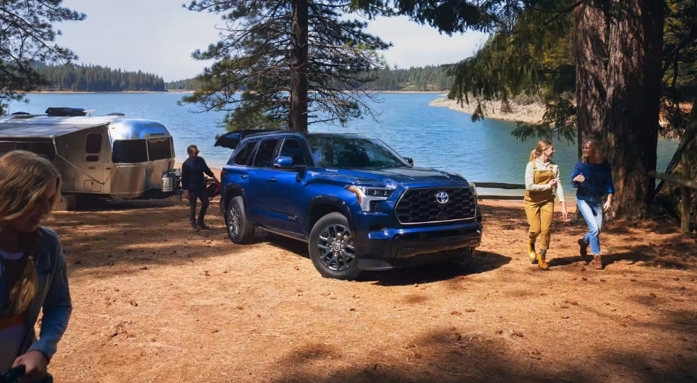 A blue 2024 Toyota Sequoia Platinum is shown near a lake after leaving a Toyota dealer near you.