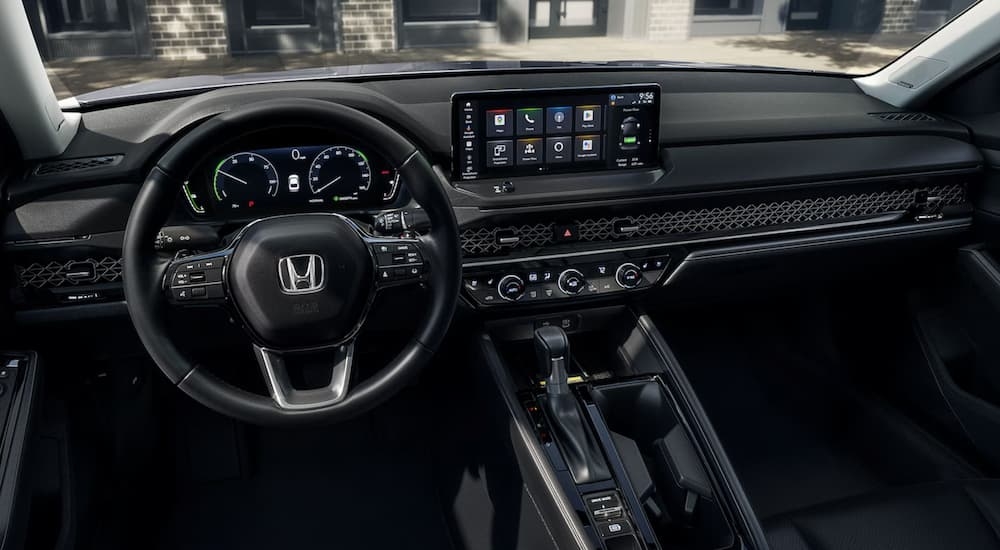 The steering wheel and infotainment screen in a 2025 Honda Accord Hybrid for sale.