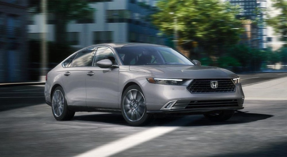 A grey 2025 Honda Accord Touring driving through the city to a Honda dealer near Nanuet.