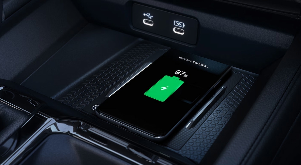 Close-up of a smartphone on the wireless charging pad in a 2025 Honda Accord Touring Hybrid.