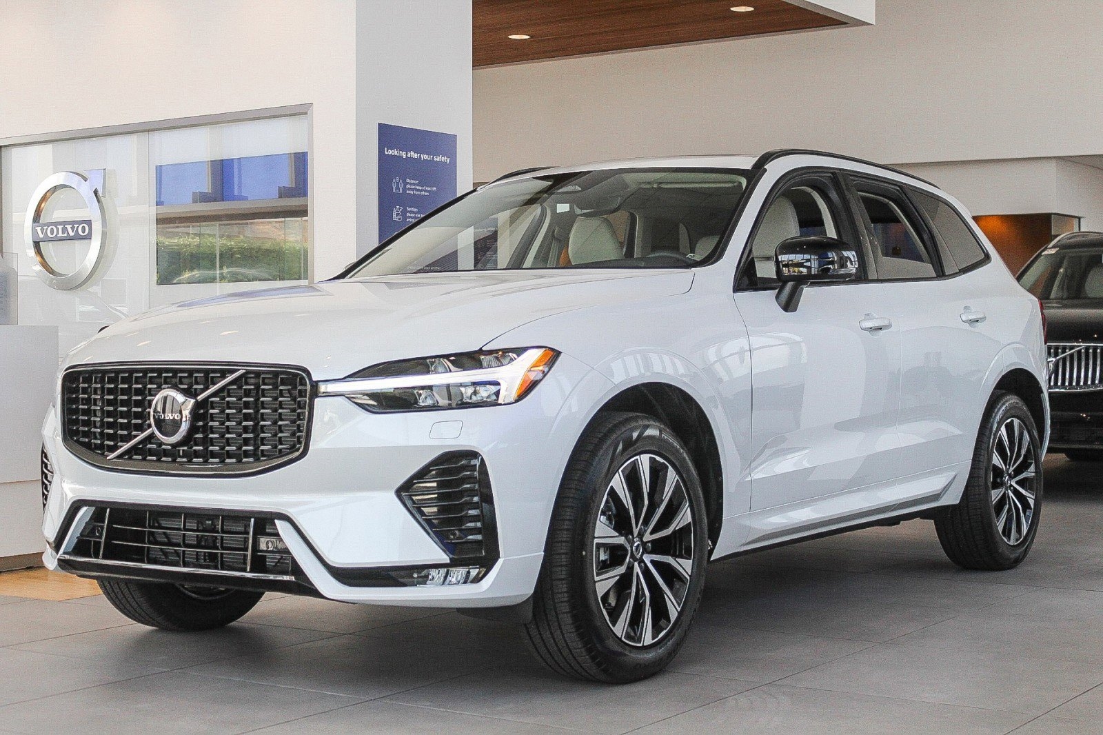 white 2025 Volvo XC60 SUV parked at the Volvo Cars Mission Viejo dealership in Mission Viejo, CA