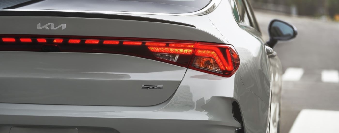 Close-up on the taillights of a white 2024 Kia K5 GT-Line.