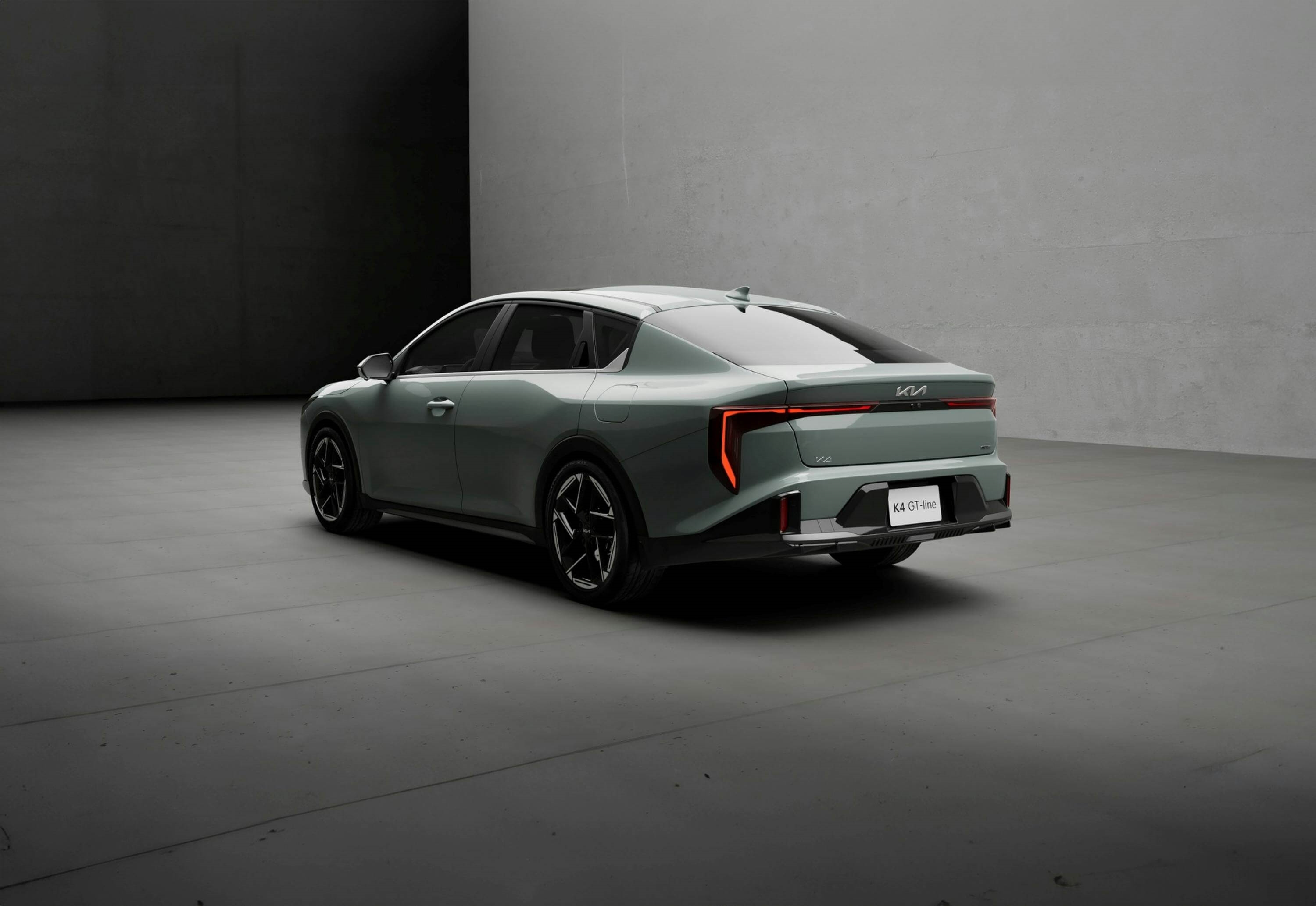 Rear 3/4 view of the Kia K4 parked against a grey backdrop.