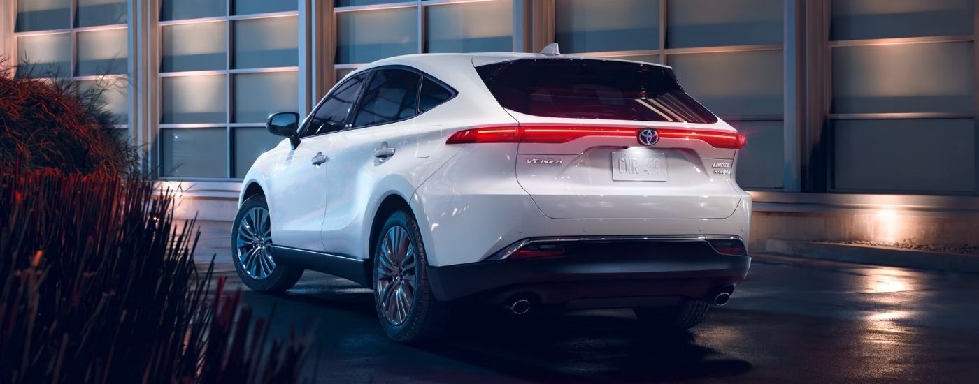 Rear view of a white 2024 Toyota Venza Limited parked at night.