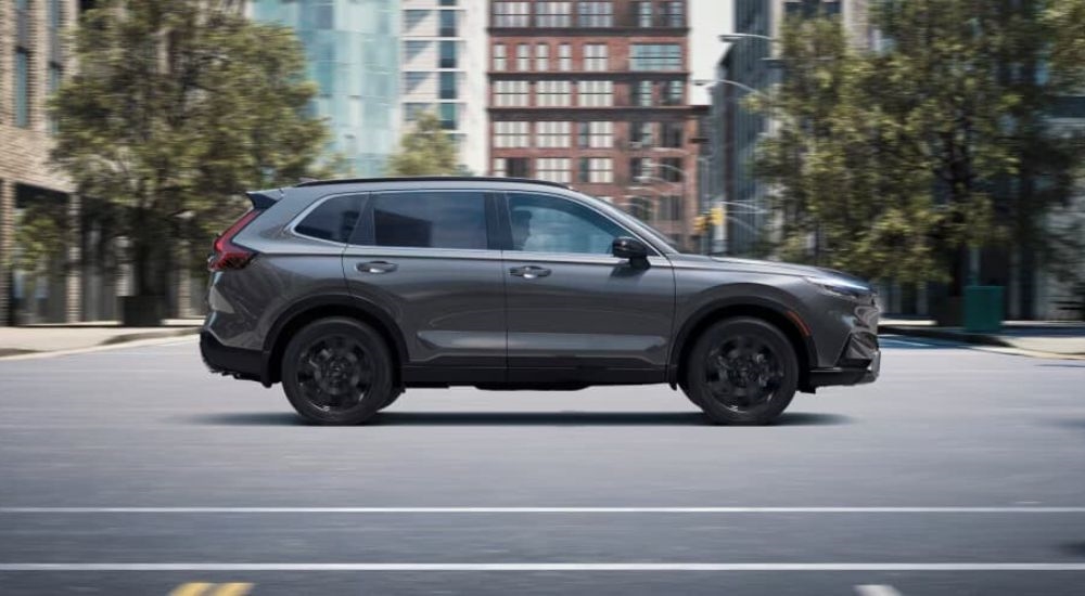 A grey  2025 Honda CR-V is shown driving to a Honda dealer near Warwick.