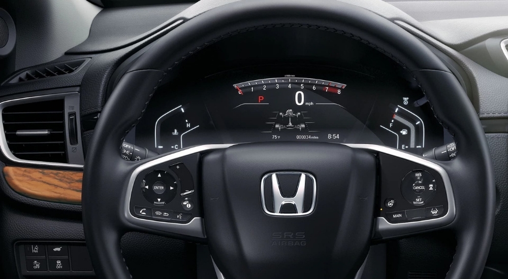 A close-up shows the digital gauge in a 2021 Honda CR-V.