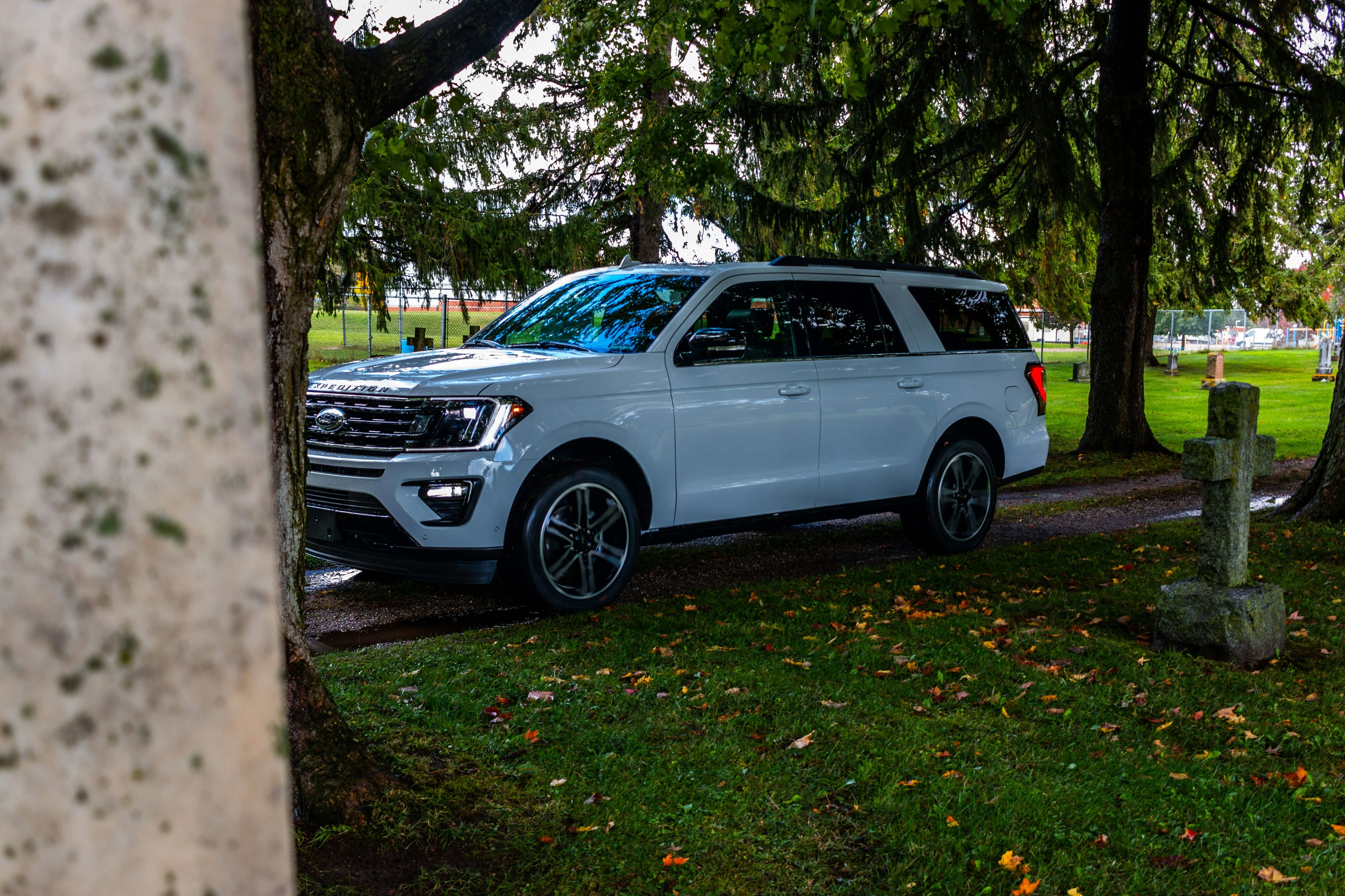 Side view of a Ford Expedition parked on a grassy road