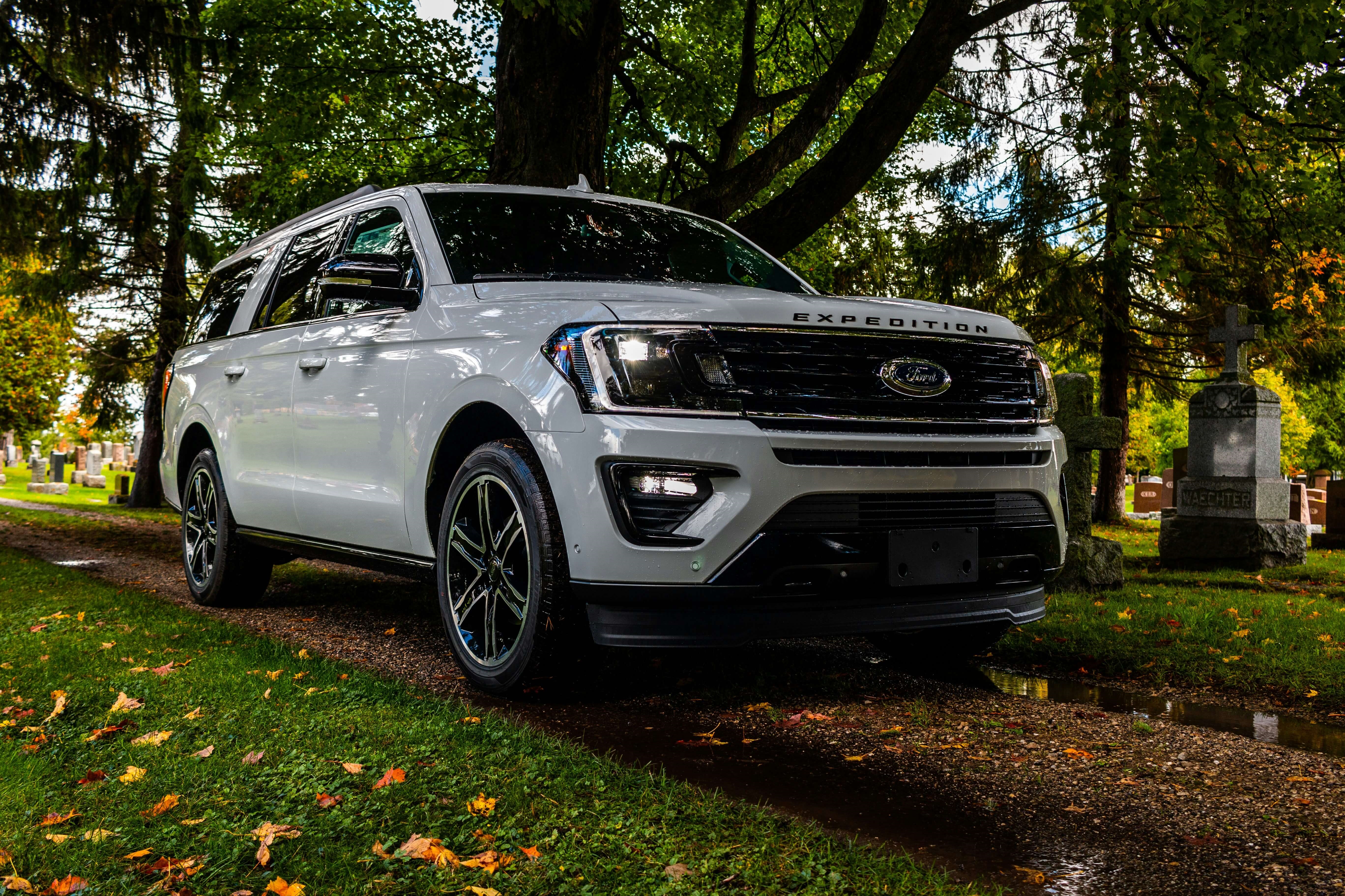 A Ford Expedition parked on a grassy road