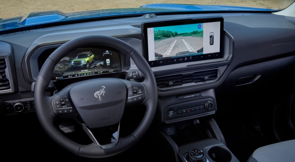 The steering wheel and infotainment screen in a 2025 Ford Bronco Sport for sale in Rhinebeck.