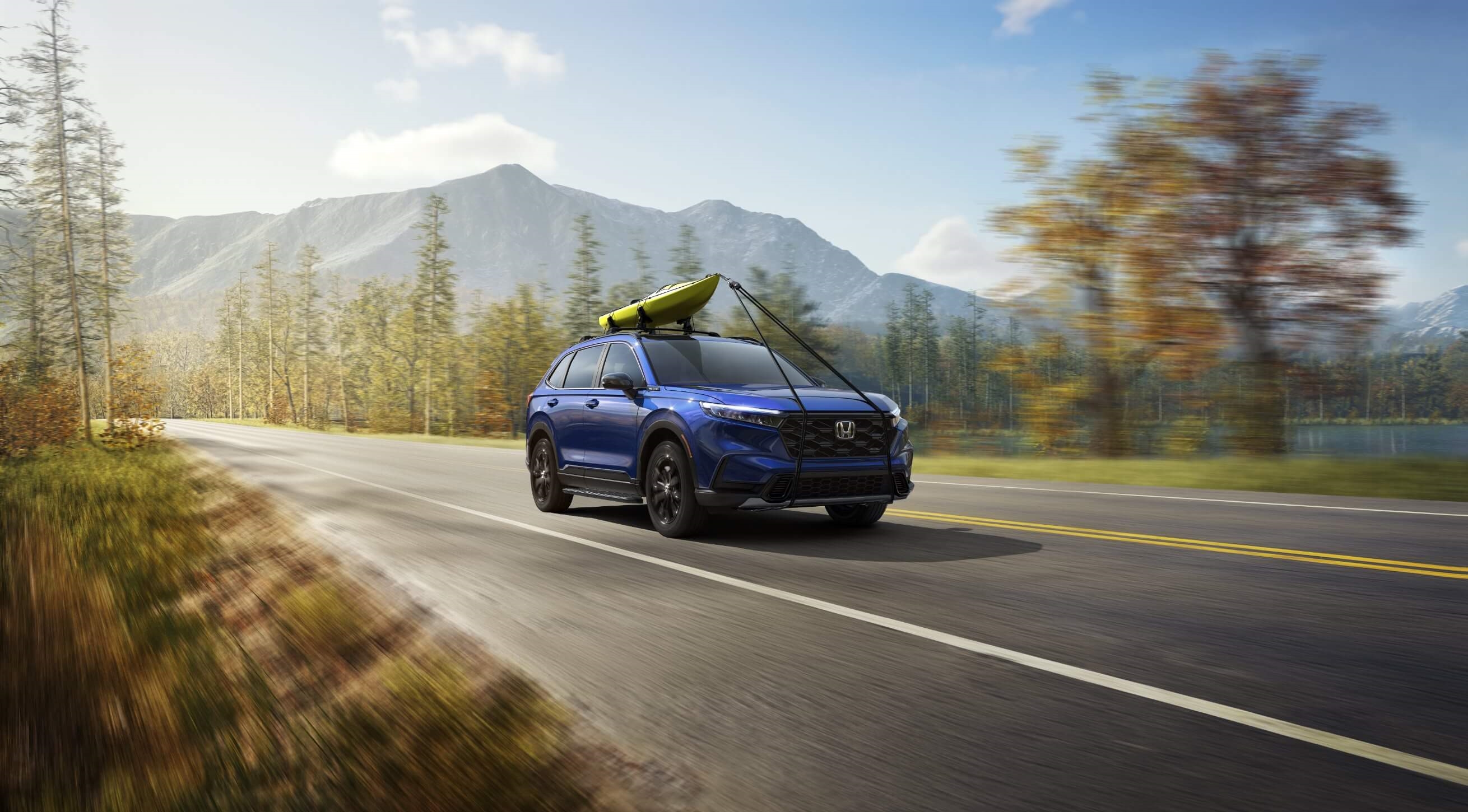 A Honda CR-V driving along a highway.