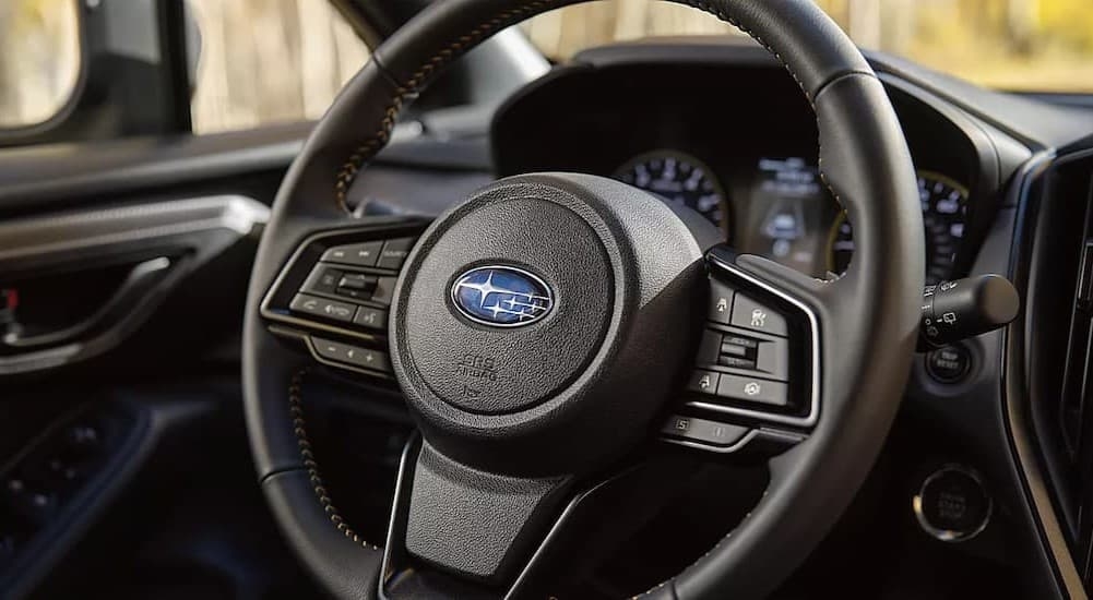 A close-up of the steering wheel is shown in a 2024 Subaru Crosstrek.