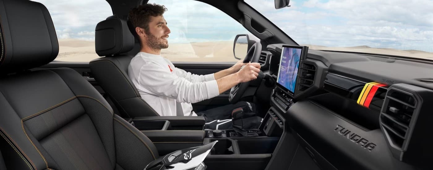 The black interior and dash are shown in a 2025 Toyota Tundra TRD Rally.