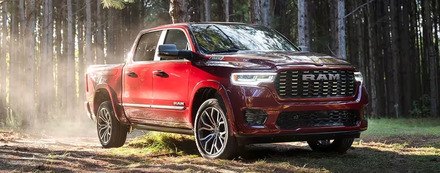 A red 2025 Ram 1500 Tungesten is shown from the front at an angle.