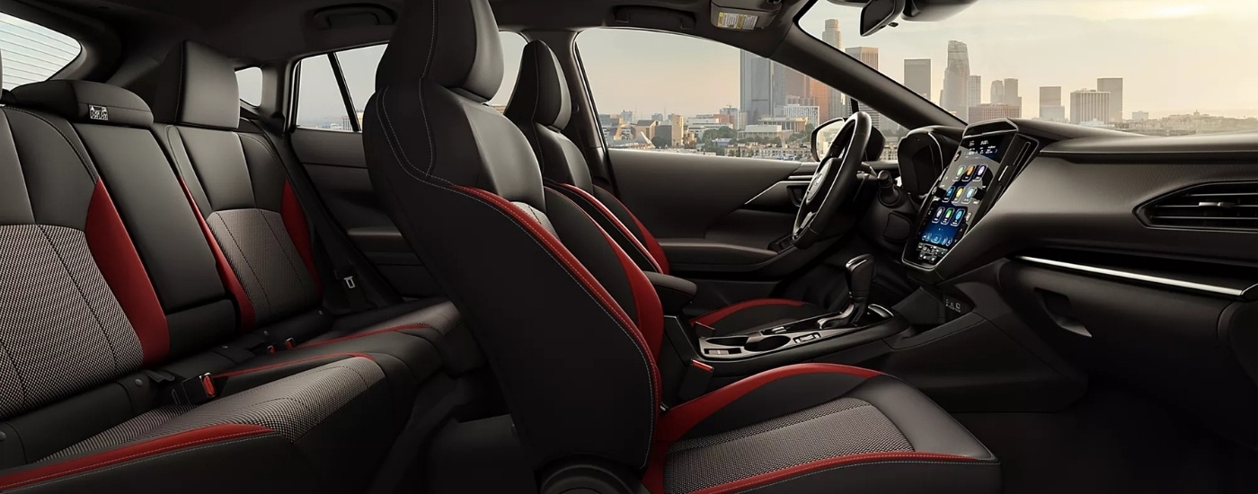 The black interior of a 2025 Subaru Impreza is shown from the passenger side.