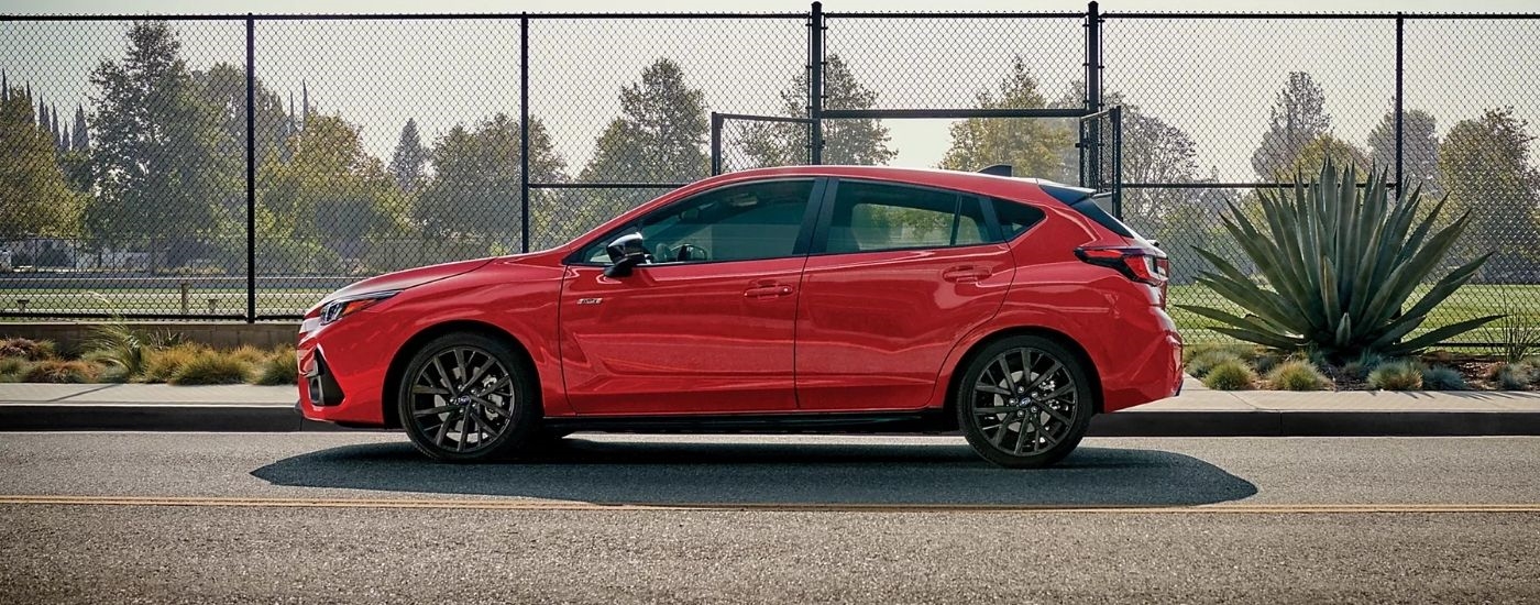 A red 2025 Subaru Impreza is shown from the side.