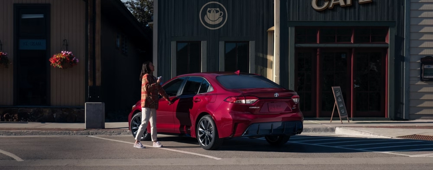 A red 2024 Toyota Corolla is shown from the rear at an angle after leaving a Toyota dealer near Concord.