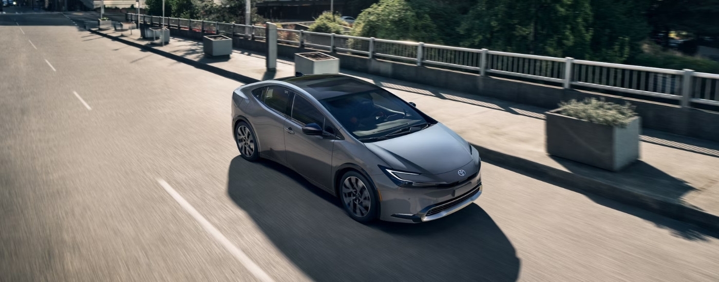 A grey 2025 Toyota Prius is shown from the front at a high angle.