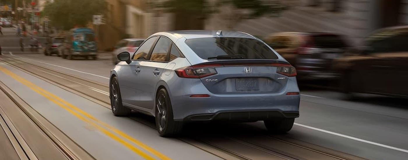 A grey 2022 Honda Civic Sport Hatchback is shown from the rear at an angle.