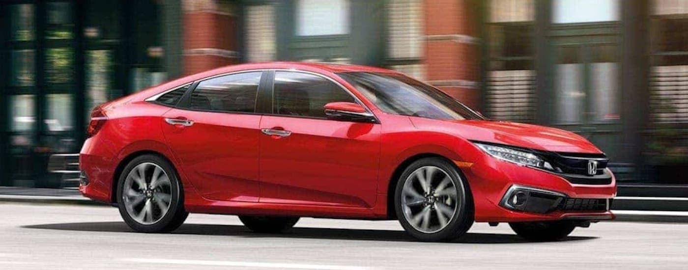 A red 2020 Honda Civic is shown from the side.