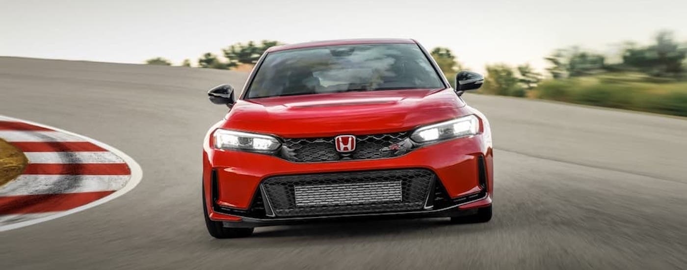 A red 2024 Honda Civic Type R is shown from the front after leavign a Honda dealer near Monroe.