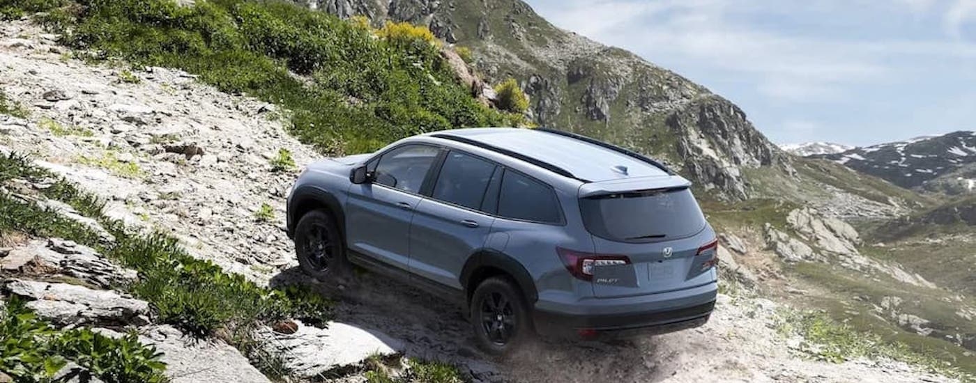 A grey 2022 Honda Pilot Trailsport is shown from the rear at an angle.