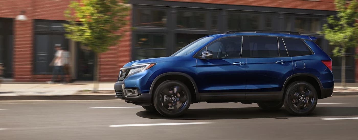 A blue 2021 Honda Pilot Elite is shown from the side.