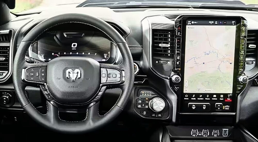 The steering wheel and infotainment screen in a 2025 Ram 1500 Big Horn.