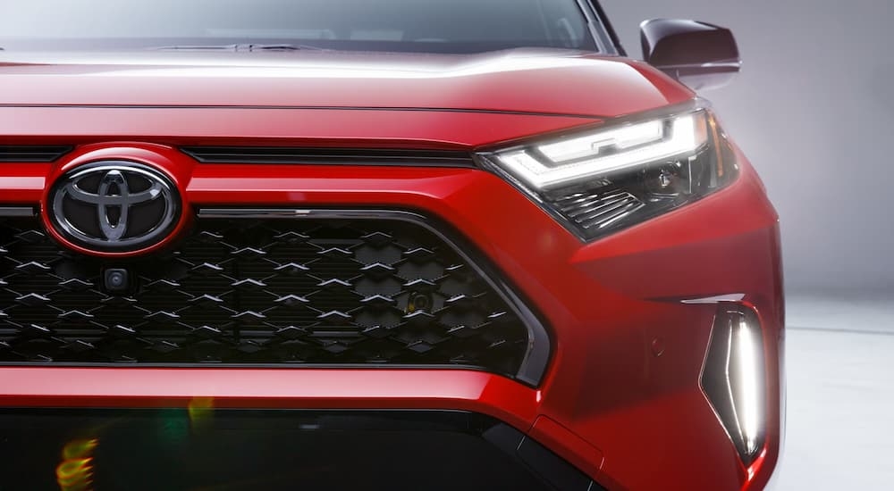 Close-up on the grille of a red 2025 Toyota RAV4.