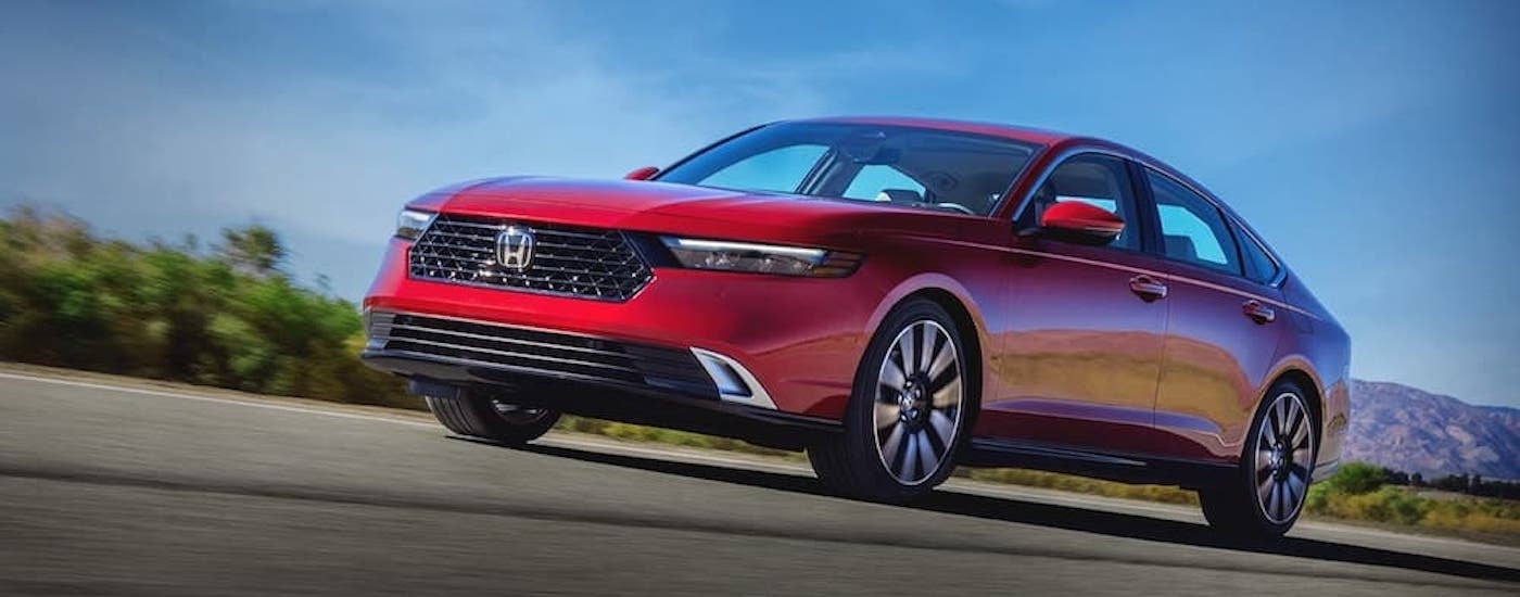 A red 2023 Honda Accord is shown from the front at an angle.