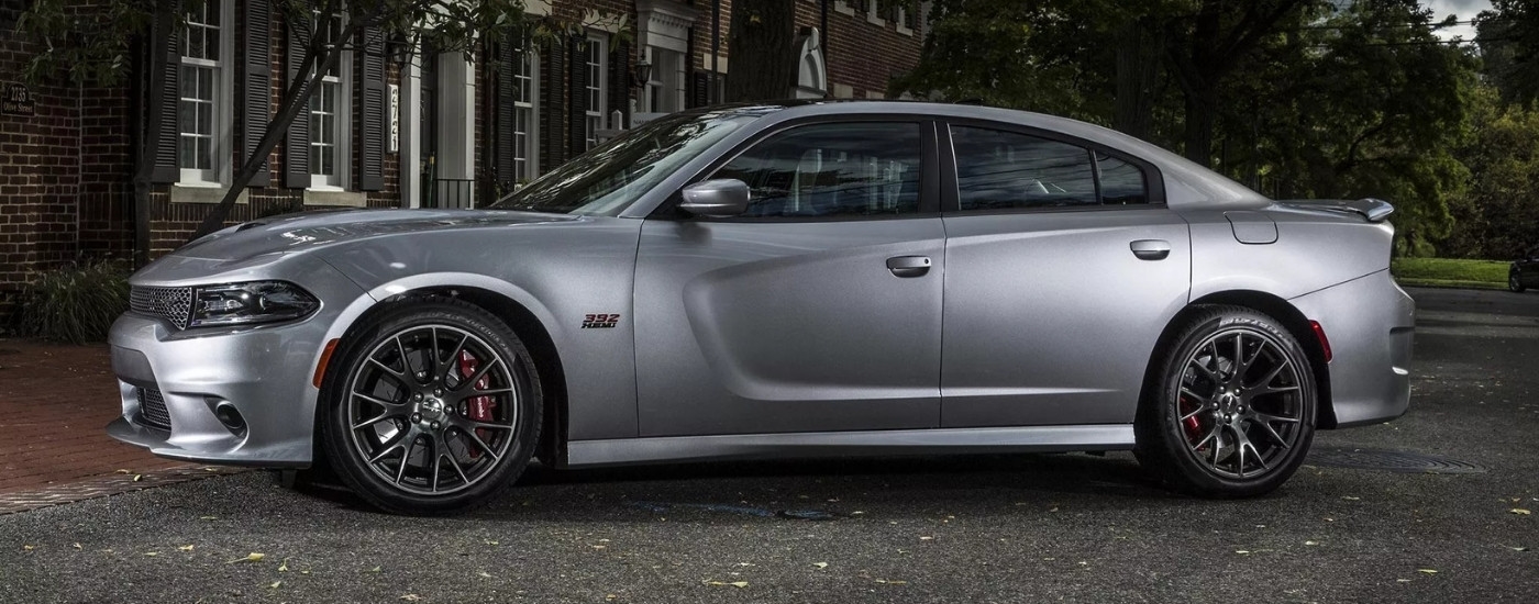 A silver 2015 Dodge Charger SRT 392 is shown parked on pavement.