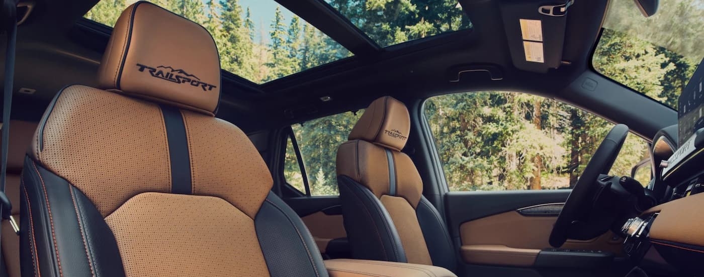 The black and brown interior is shown in a 2026 Honda Passport TrailSport Elite.