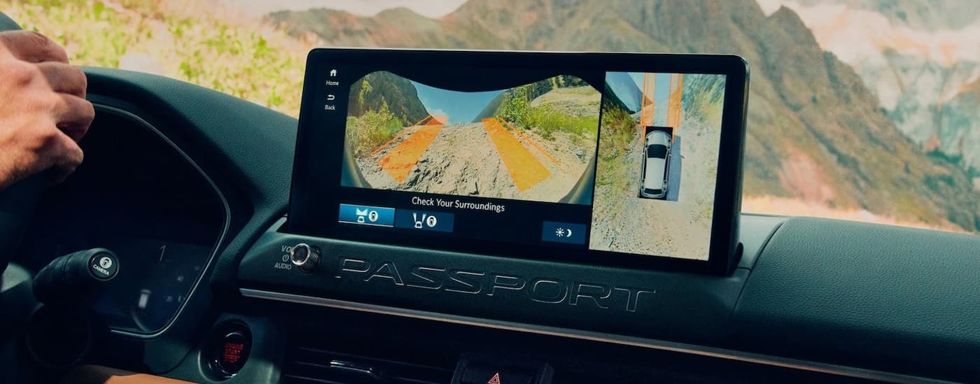 A close-up of the infotainment screen is shown in a 2026 Honda TrailSport Elite.