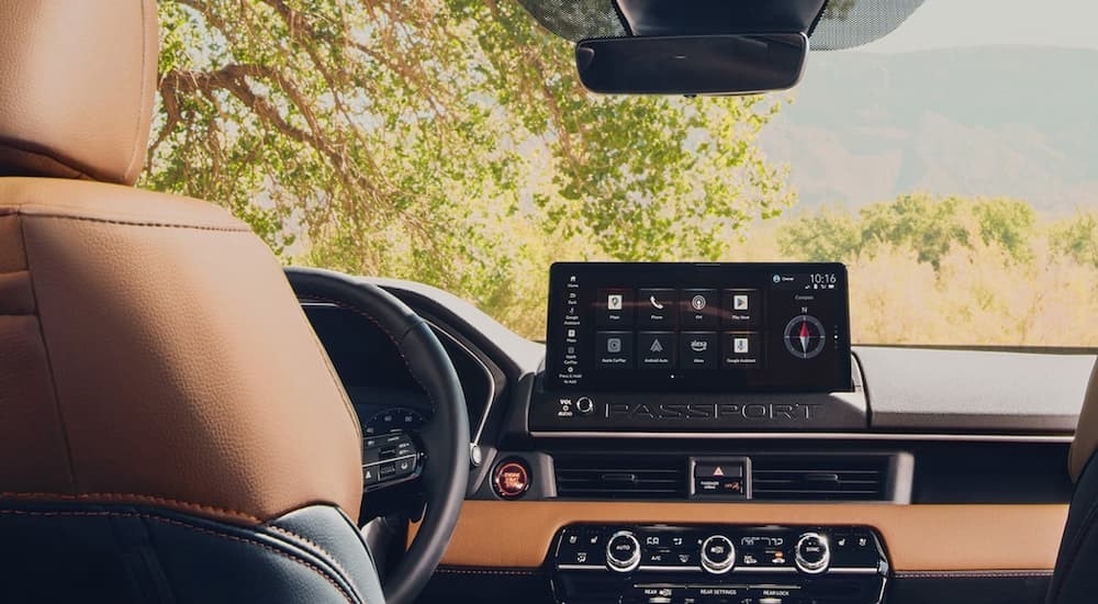 The black and brown dash is shown in a 2026 Honda Passport TrailSport Elite.