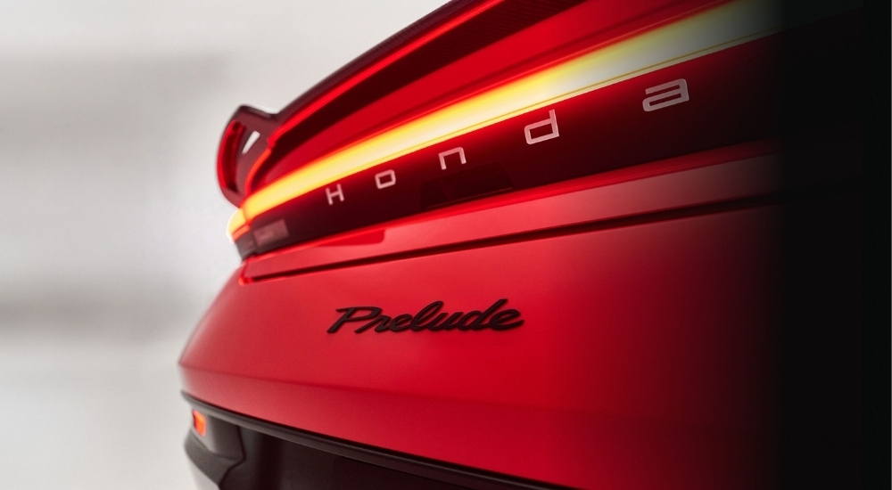 Close-up of the rear badge and spoiler of a red 2026 Honda Prelude at a local Honda dealer.